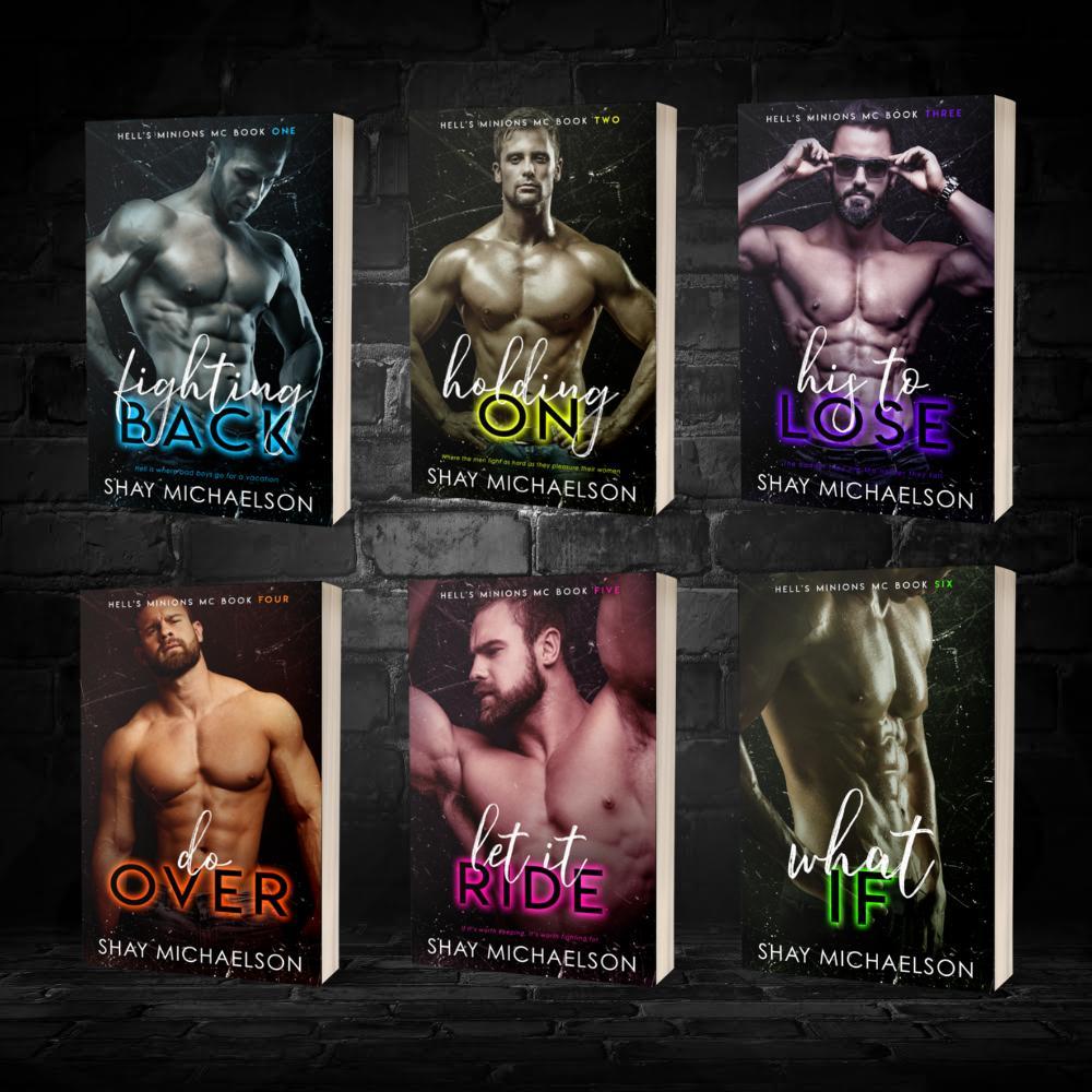 Six book covers are displayed against a dark brick wall, each featuring a shirtless man in various poses. Titles and colors vary, conveying a bold, edgy tone.